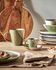 White and green Naara coffee cup with plate